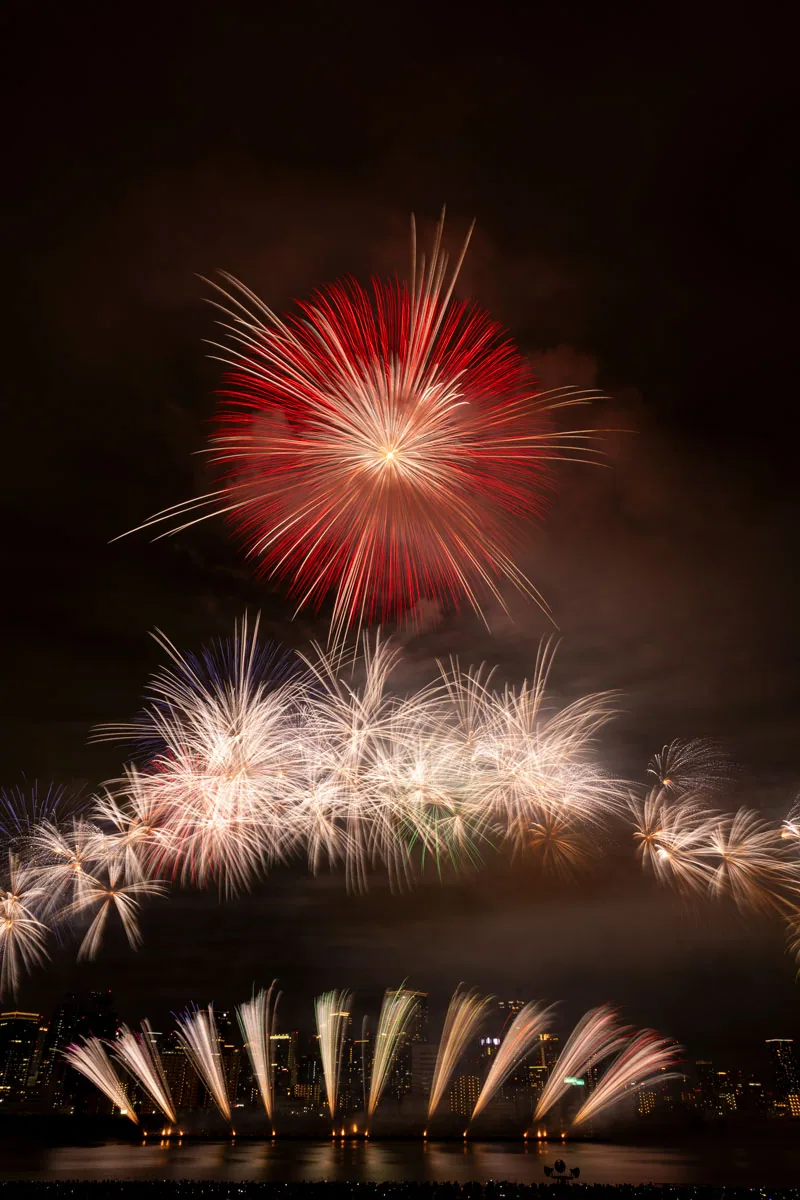 Feuerwerk über dem Yodogawa und die nächtliche Skyline von Osaka